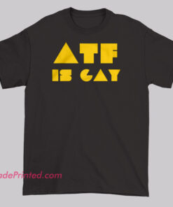 T-shirt design with bold text 'ATF IS GAY,' commonly seen on apparel and merchandise as both an LGBTQ+ pride statement and satirical commentary on the Bureau of Alcohol, Tobacco, Firearms and Explosives.