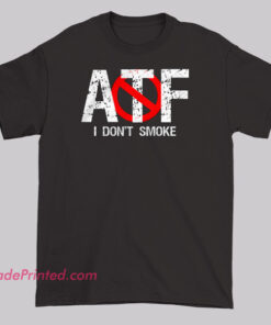 T-shirt design with distressed white 'ATF' text, featuring a red no-smoking symbol over the 'T' and 'F,' and the phrase 'I DON'T SMOKE' below, parodying the tobacco reference in the ATF acronym.